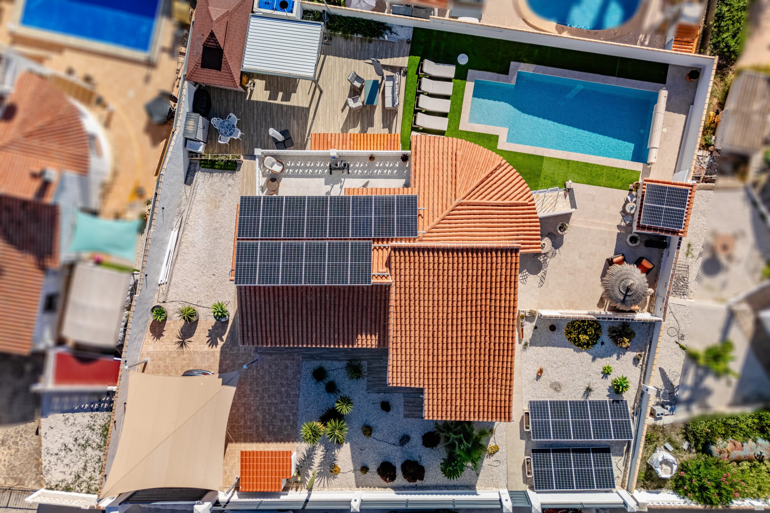 Aerial view of modern villa in Calpe with private pool and solar panels