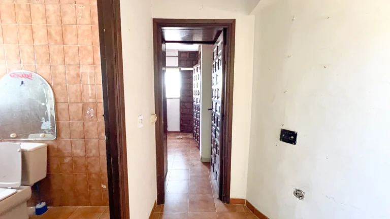 Bathroom entrance with outdated tiles in a renovation villa in Calpe