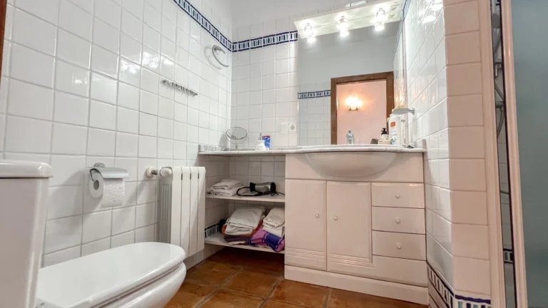 Bathroom with large vanity and blue border tiles in Benissa rustic villa