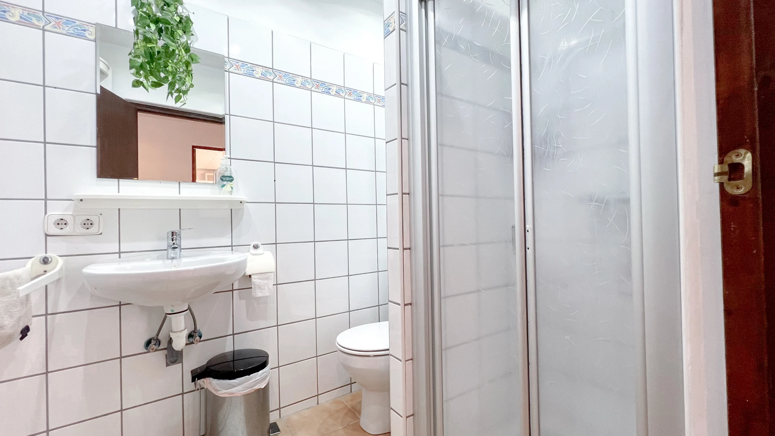 Bathroom with shower and white tiles in Benissa finca
