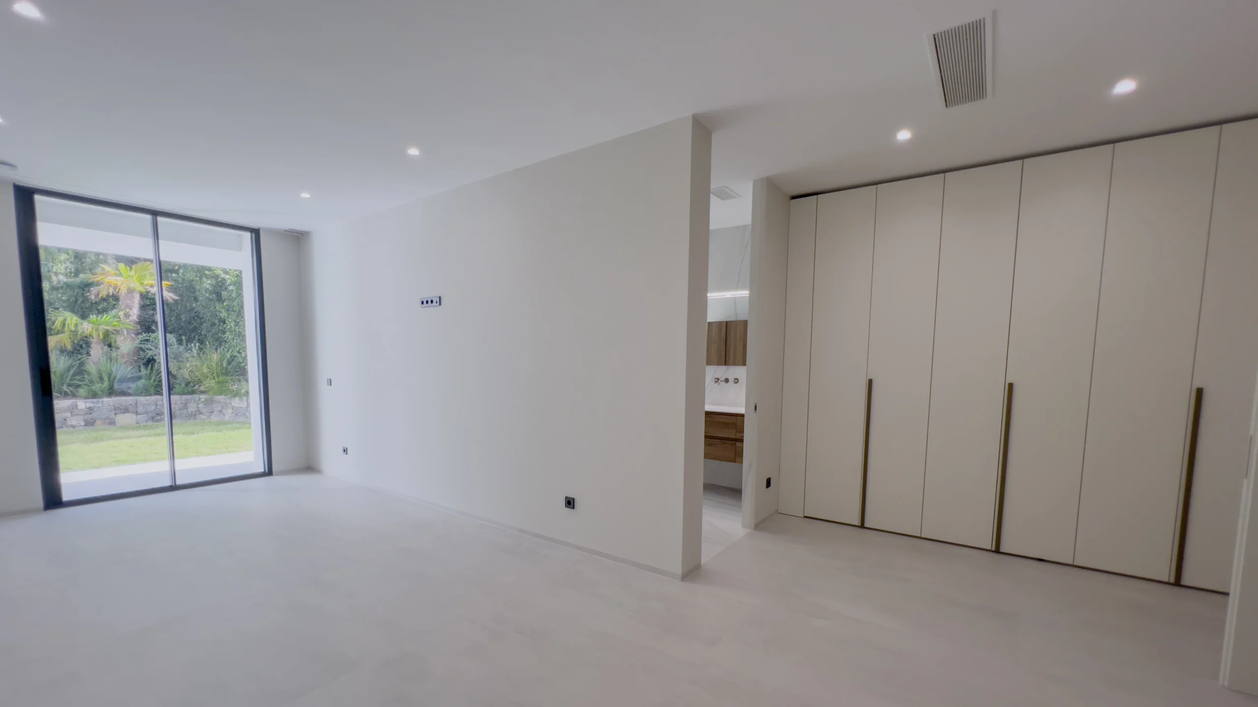 Bedroom with floor-to-ceiling wardrobes and terrace access in Altea villa