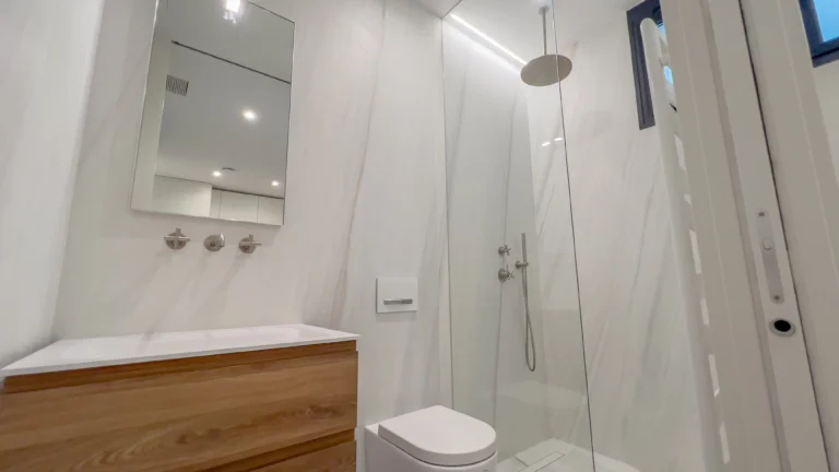 Contemporary bathroom with rain shower and wood vanity in luxury Altea villa