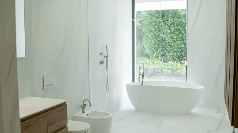 Contemporary ensuite bathroom with marble walls and garden views in Altea