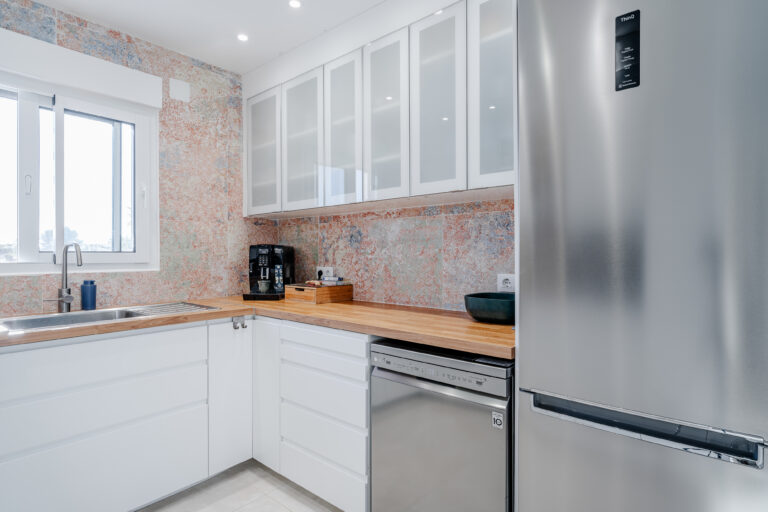 Contemporary kitchen with glass cabinets and wood countertop in a Mediterranean villa