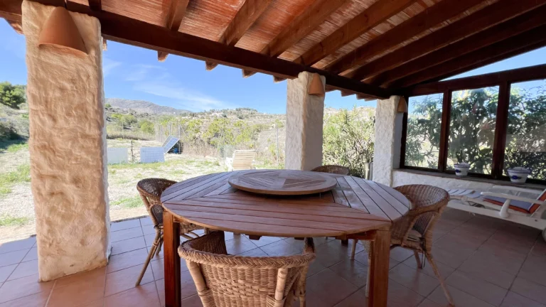 Covered terrace with wooden beams and mountain views in a Benissa finca