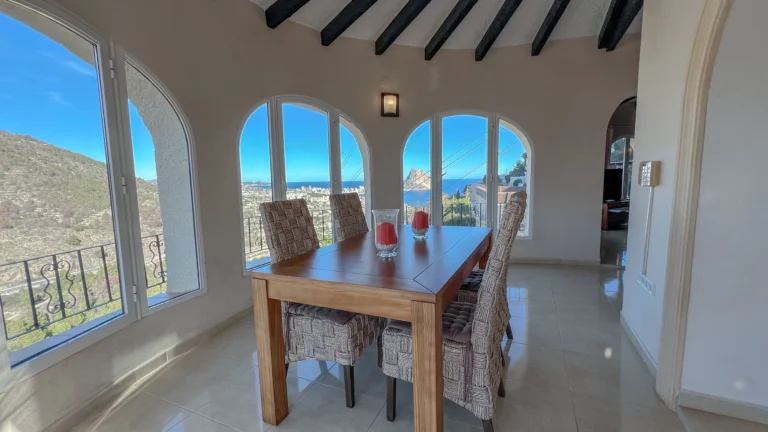 Dining room with arched windows and panoramic mountain views in Maryvilla