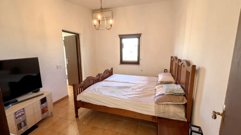 Double bedroom with wooden bed frame in Benissa finca