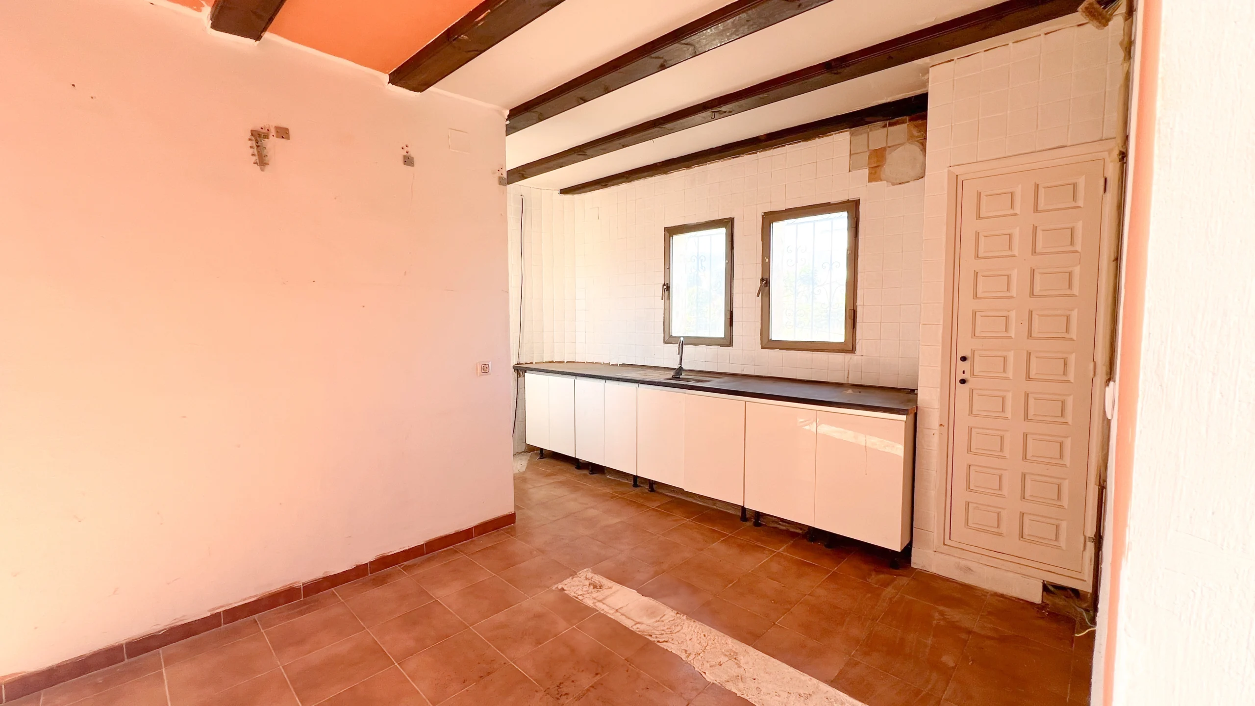 Empty kitchen space ready for renovation with tiled flooring in Calpe villa
