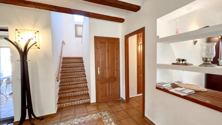 Entrance hallway with wooden beams and tiled floor in Benissa finca