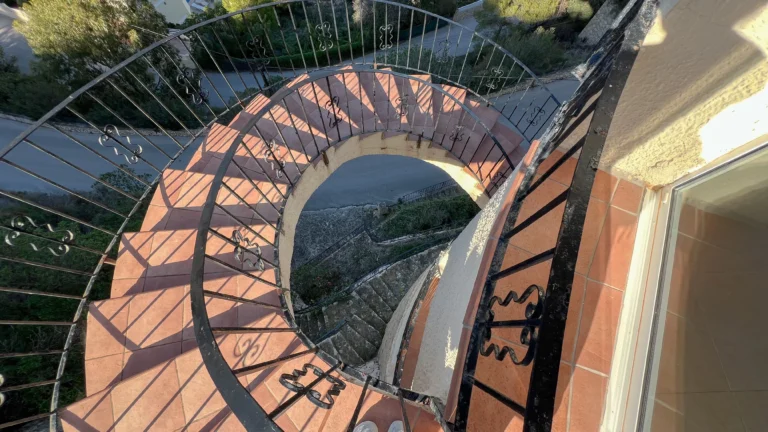 Exterior spiral staircase with iron railing at Maryvilla Calpe villa