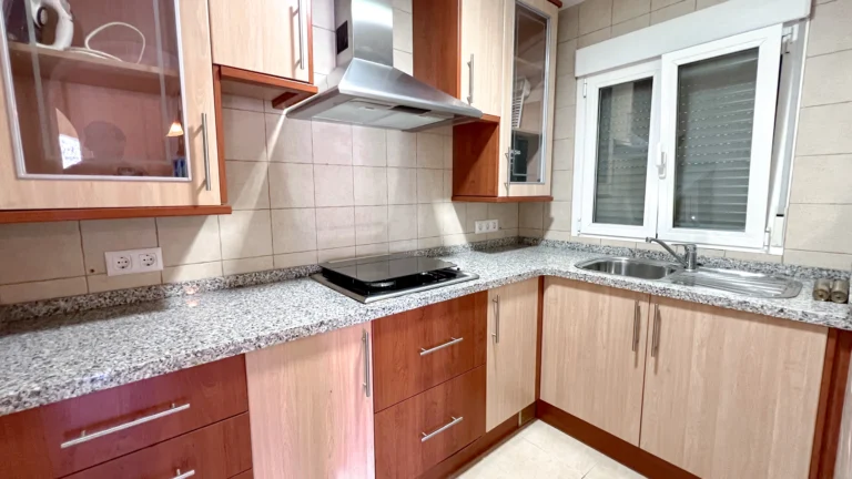 Fully equipped kitchen with wood cabinetry and granite worktops in Maryvilla