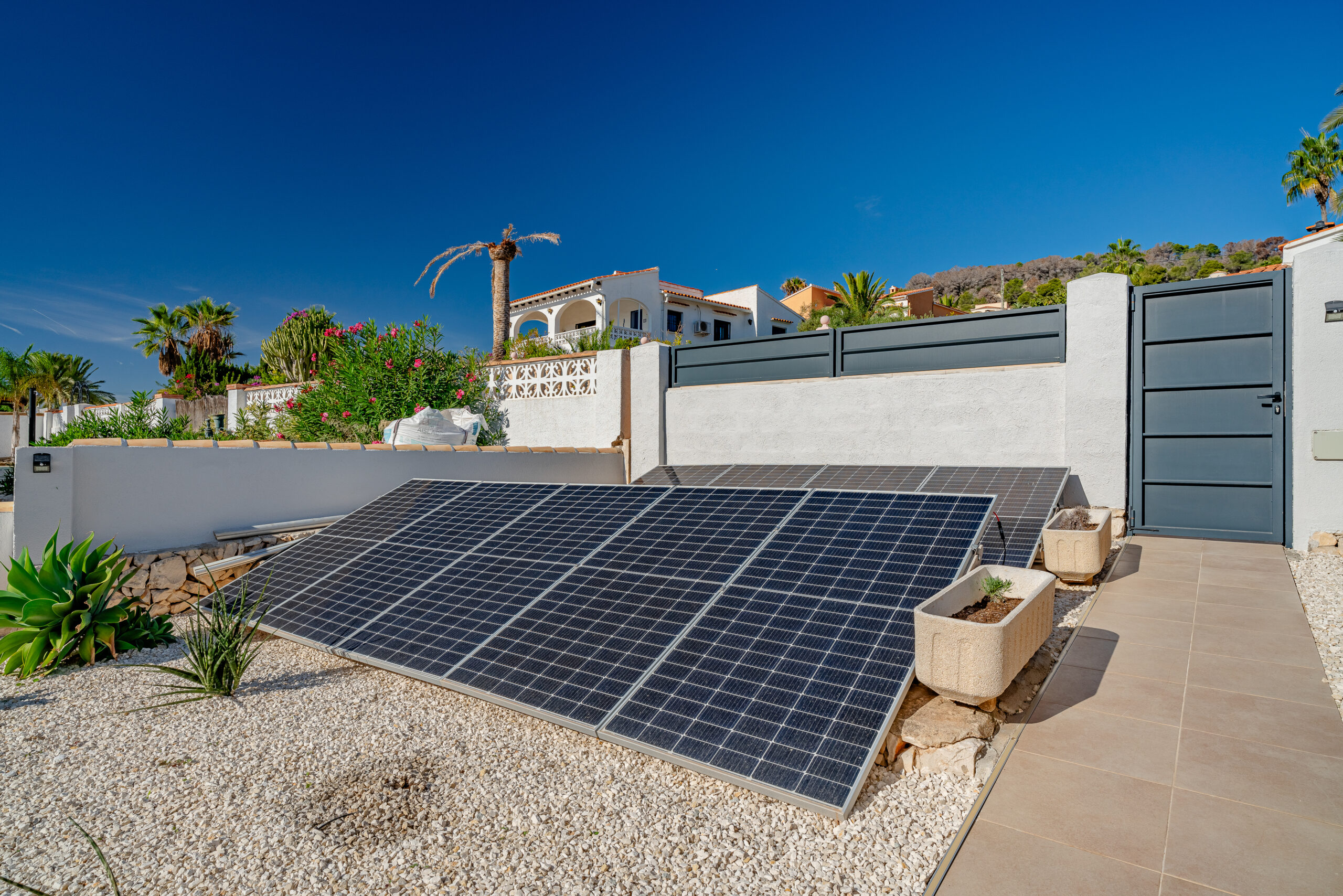 Ground-mounted solar panels in the garden of an energy-efficient villa in Calpe