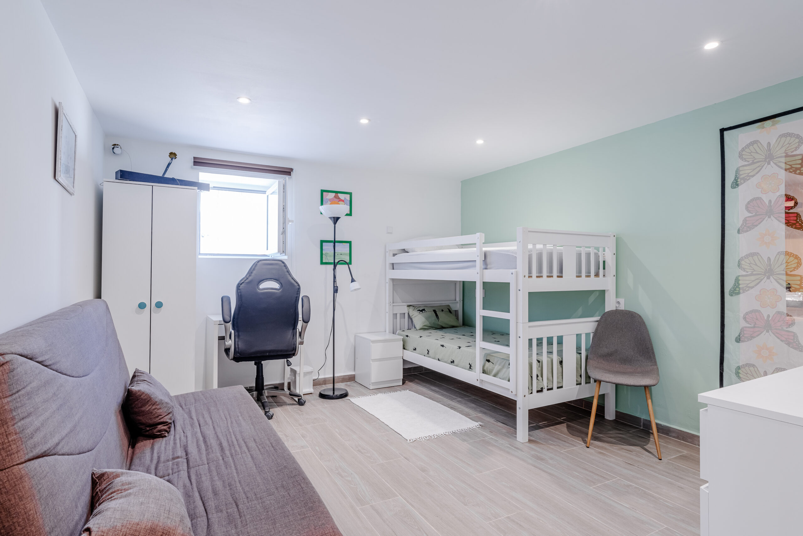 Guest apartment bedroom with bunk beds and desk in a modern sea-view villa in Calpe