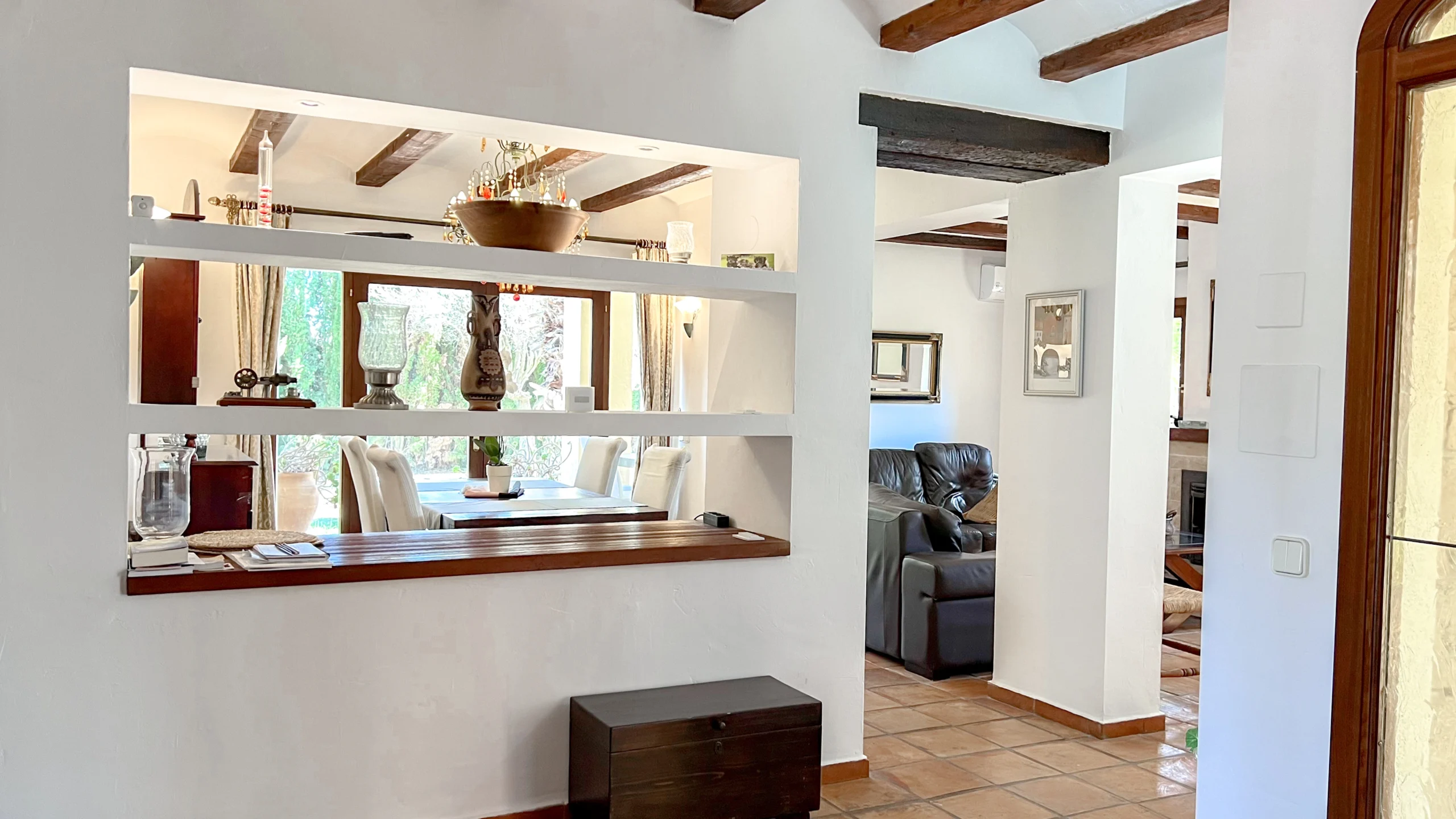 Interior pass-through shelf connecting living and dining rooms in Benissa finca