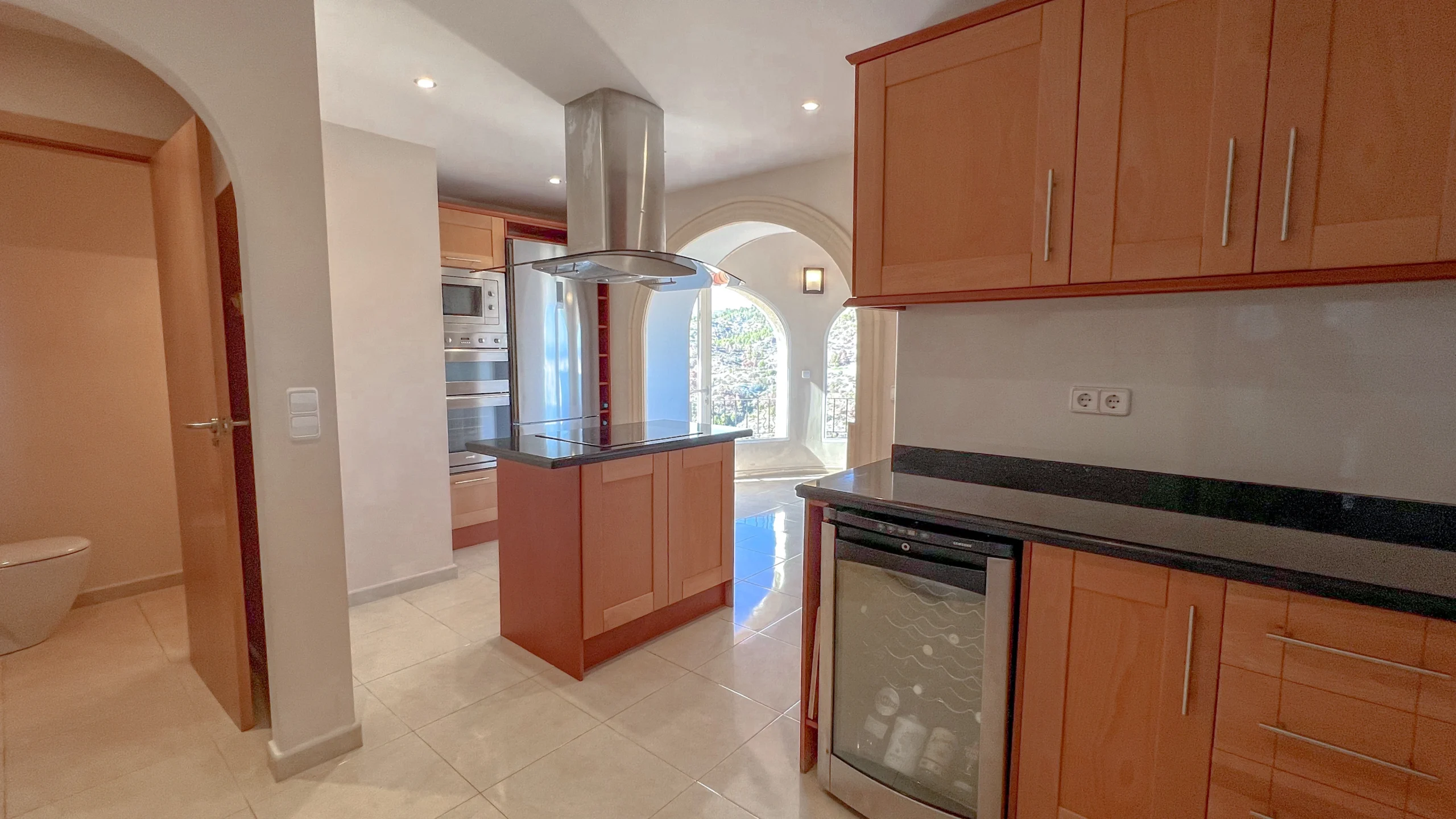 Kitchen with wooden cabinets and island in Maryvilla Calpe sea-view villa