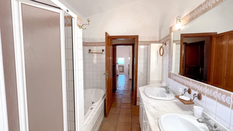Large bathroom with bathtub shower and twin basins in Benissa villa