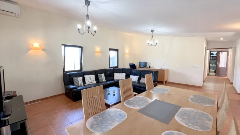 Large dining table and lounge area in rustic Benissa villa