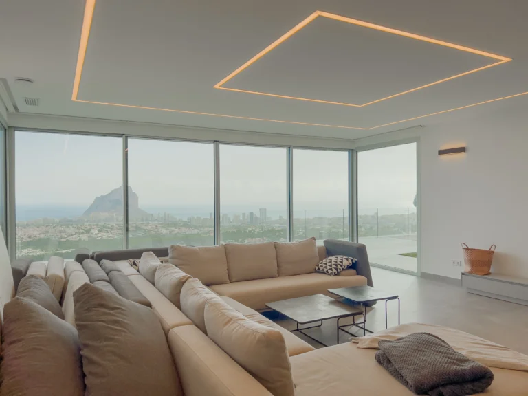 Large living room with corner sofa and skyline views of Calpe and Peñón de Ifach