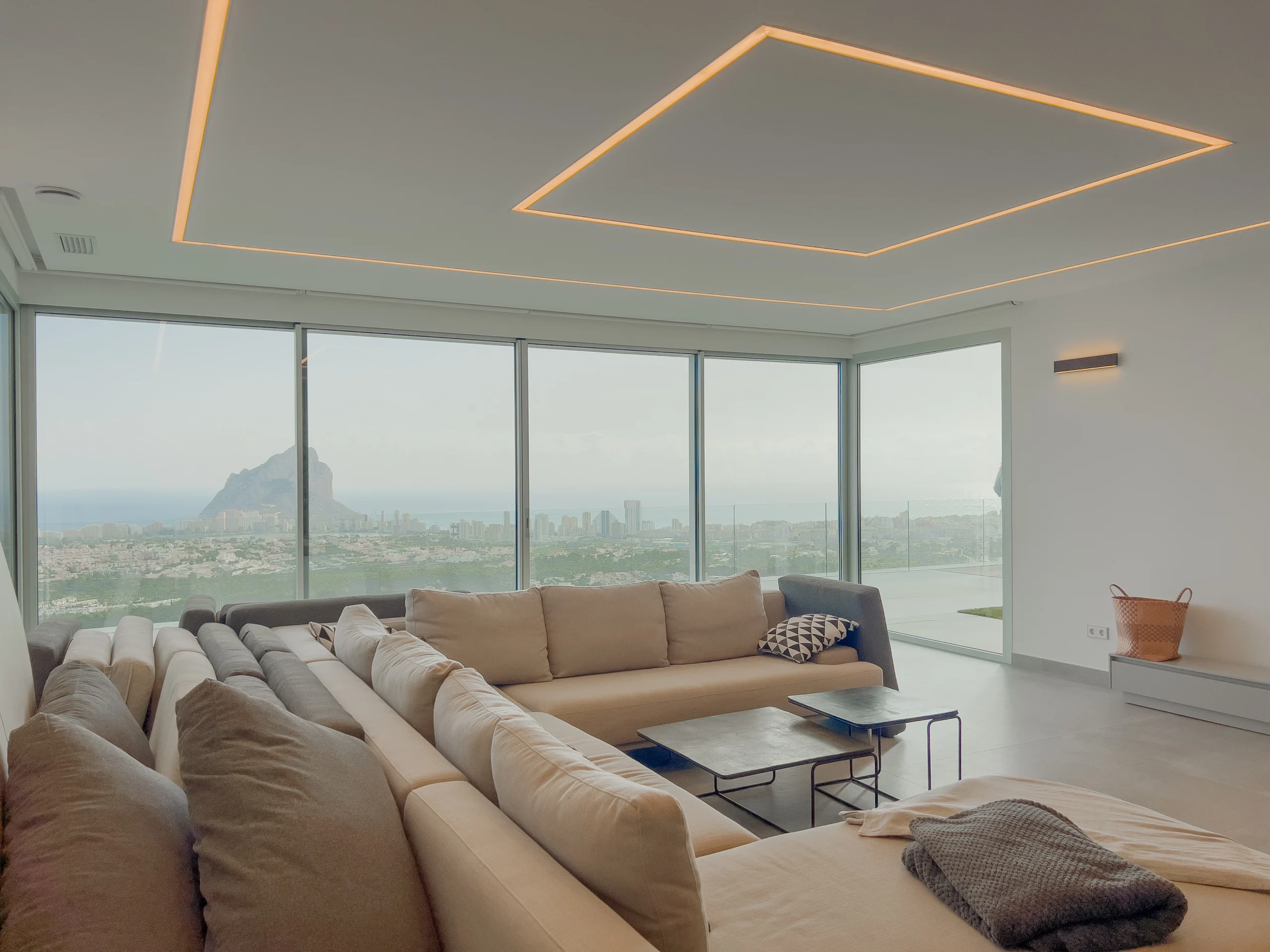 Large living room with corner sofa and skyline views of Calpe and Peñón de Ifach