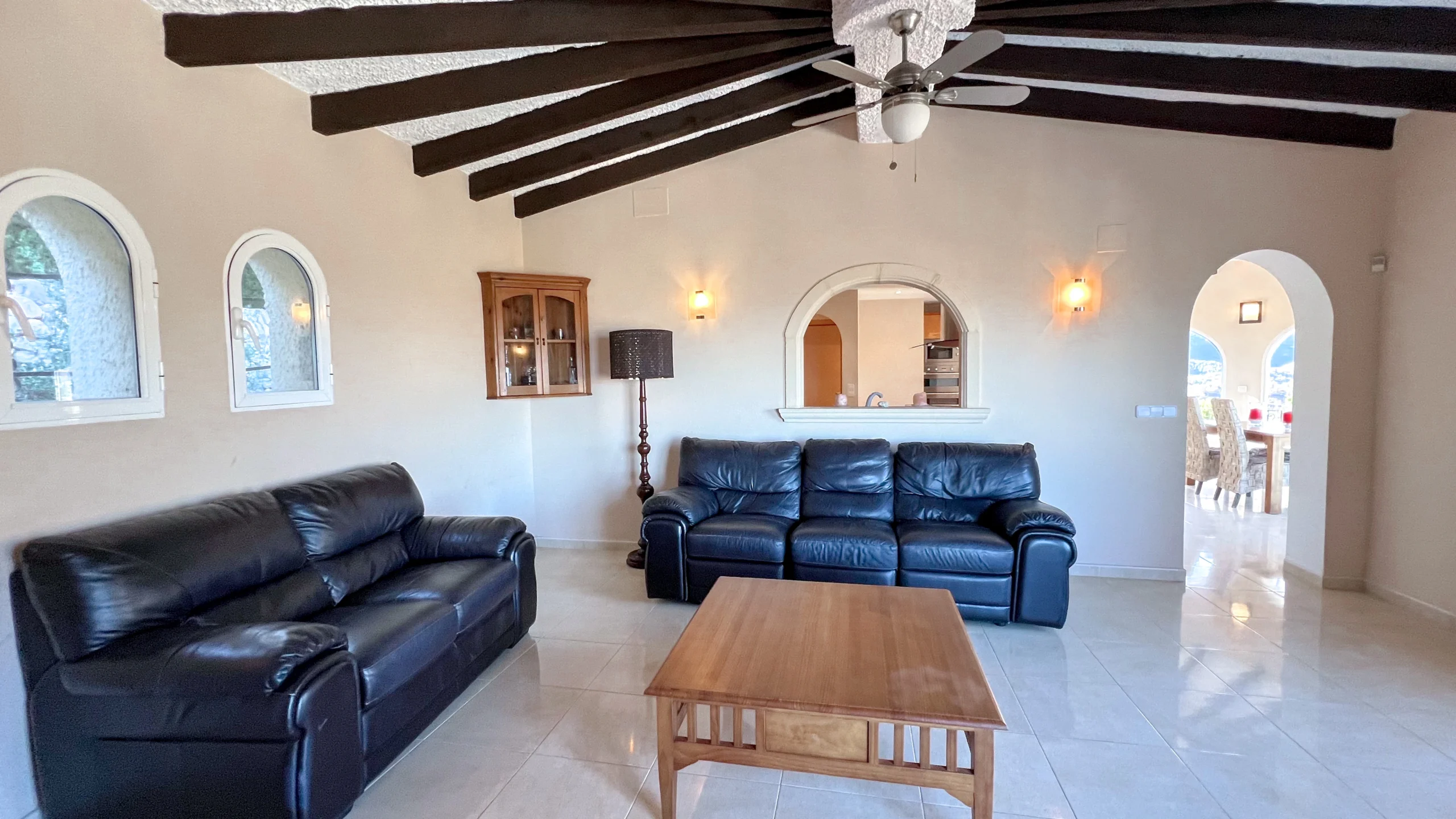 Lounge with arched windows and wooden beams in Maryvilla villa Calpe