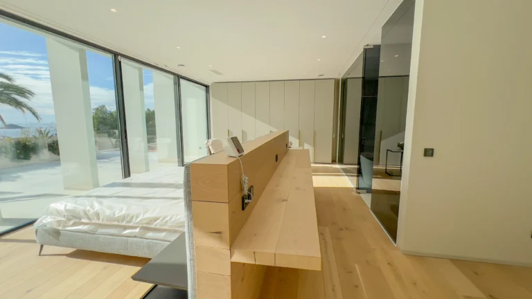 Minimalist luxury bedroom with glass walls and sea views in Altea