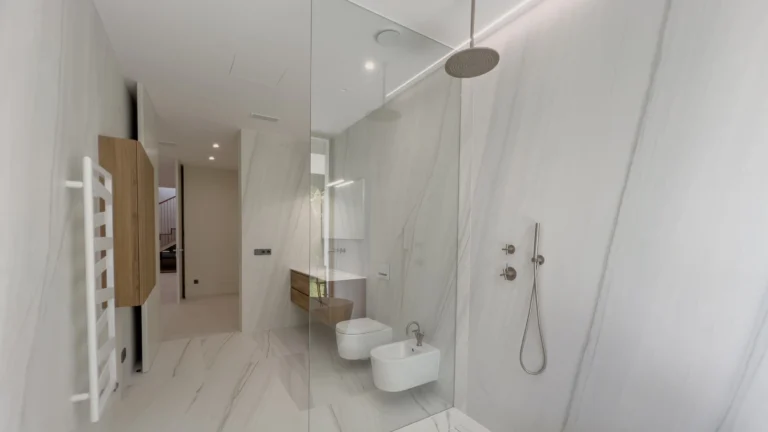 Minimalist marble bathroom with walk-in shower in first-line villa Altea