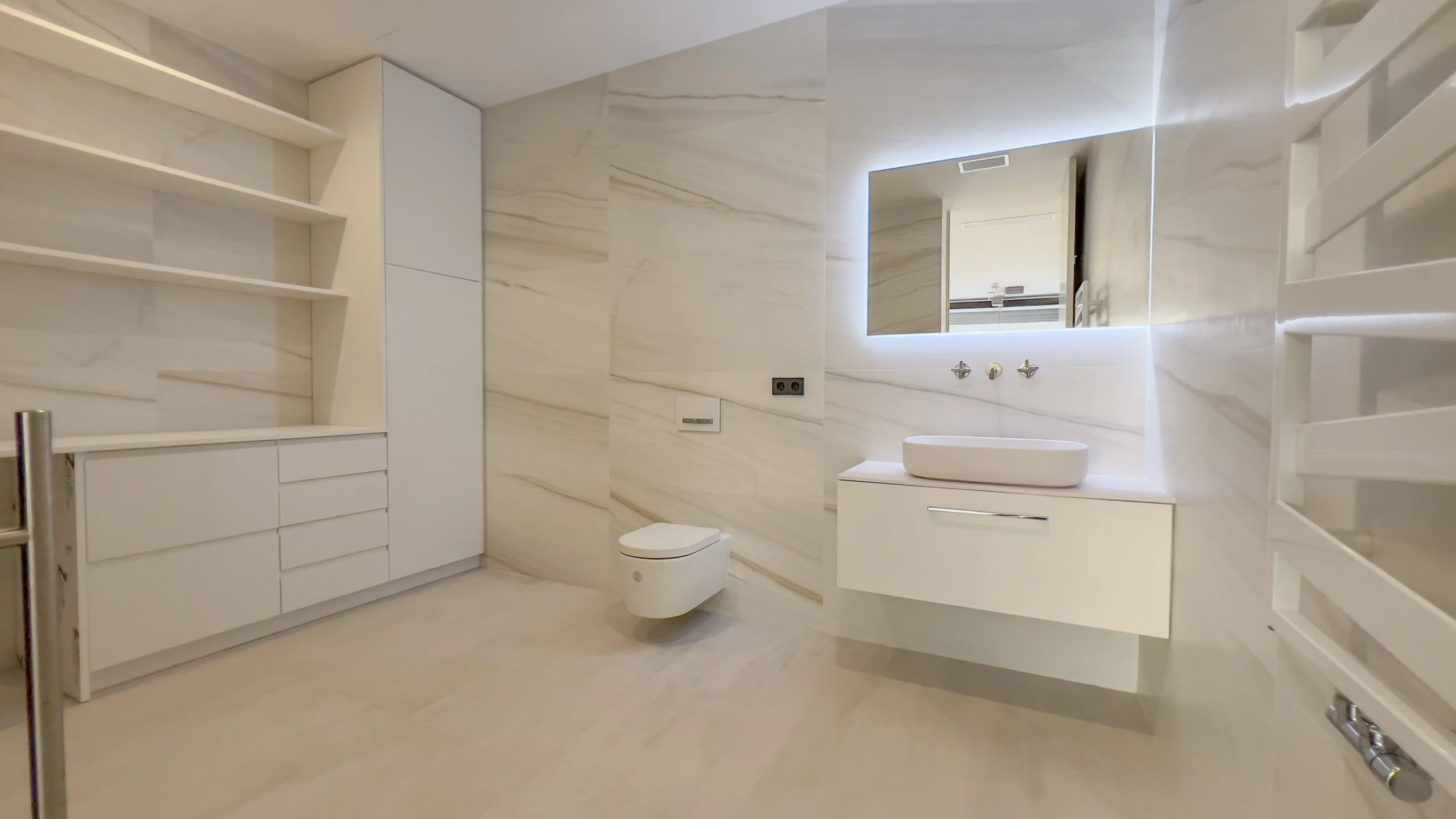 Modern bathroom with illuminated mirror and built-in storage in Altea villa