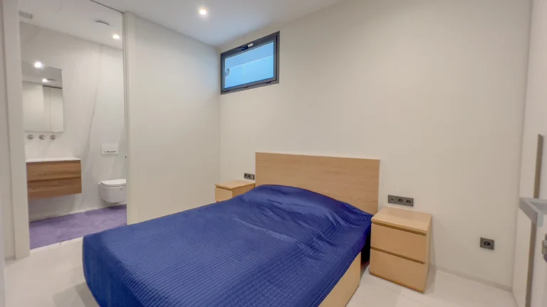 Modern bedroom with ensuite bathroom in first-line luxury villa Altea