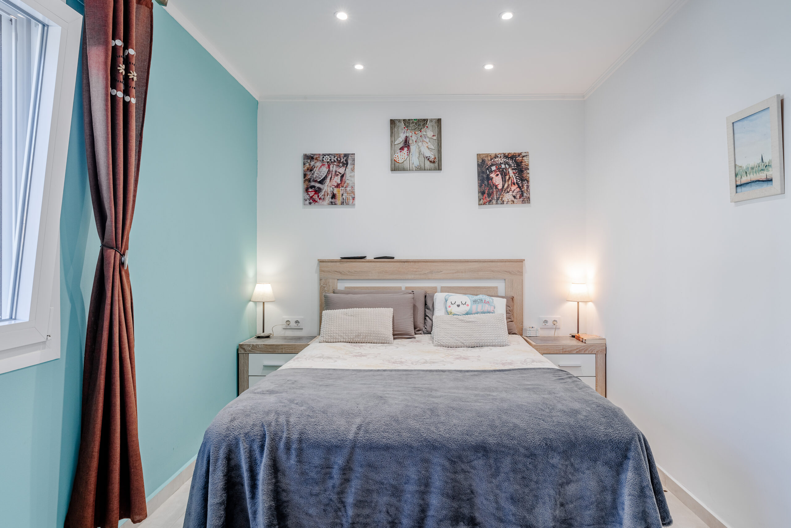 Modern double bedroom with accent wall and bedside lamps in a Mediterranean villa