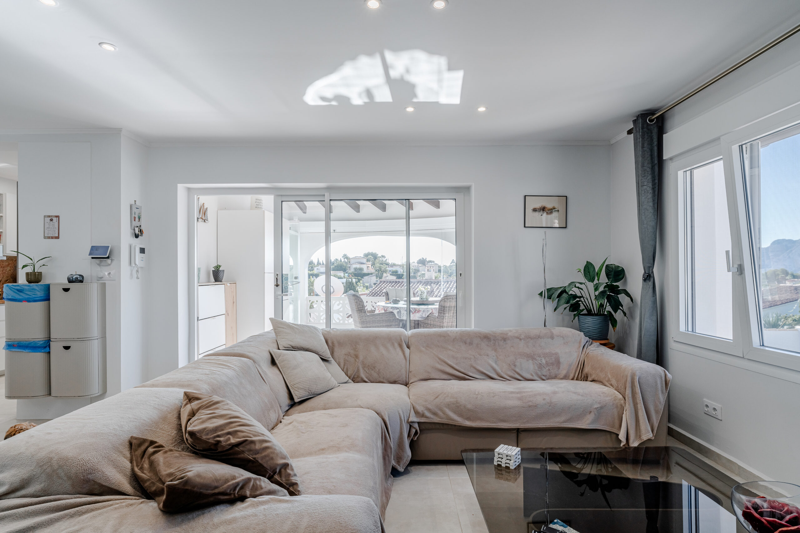 Modern living room with large sofa and terrace access in a Mediterranean villa in Calpe