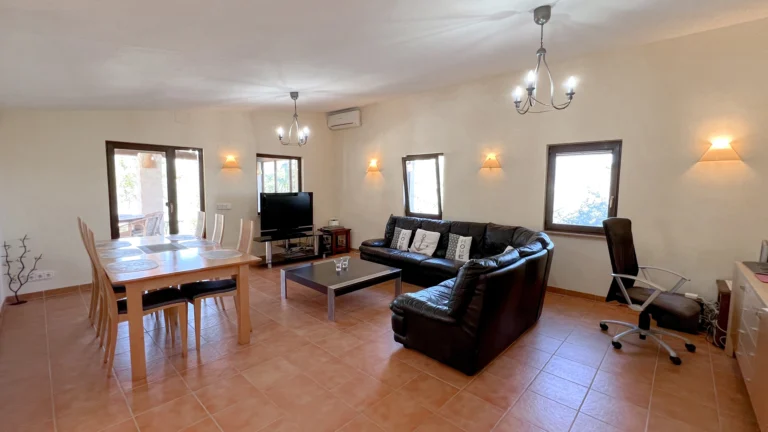 Open living and dining room with leather sofa in Benissa country house