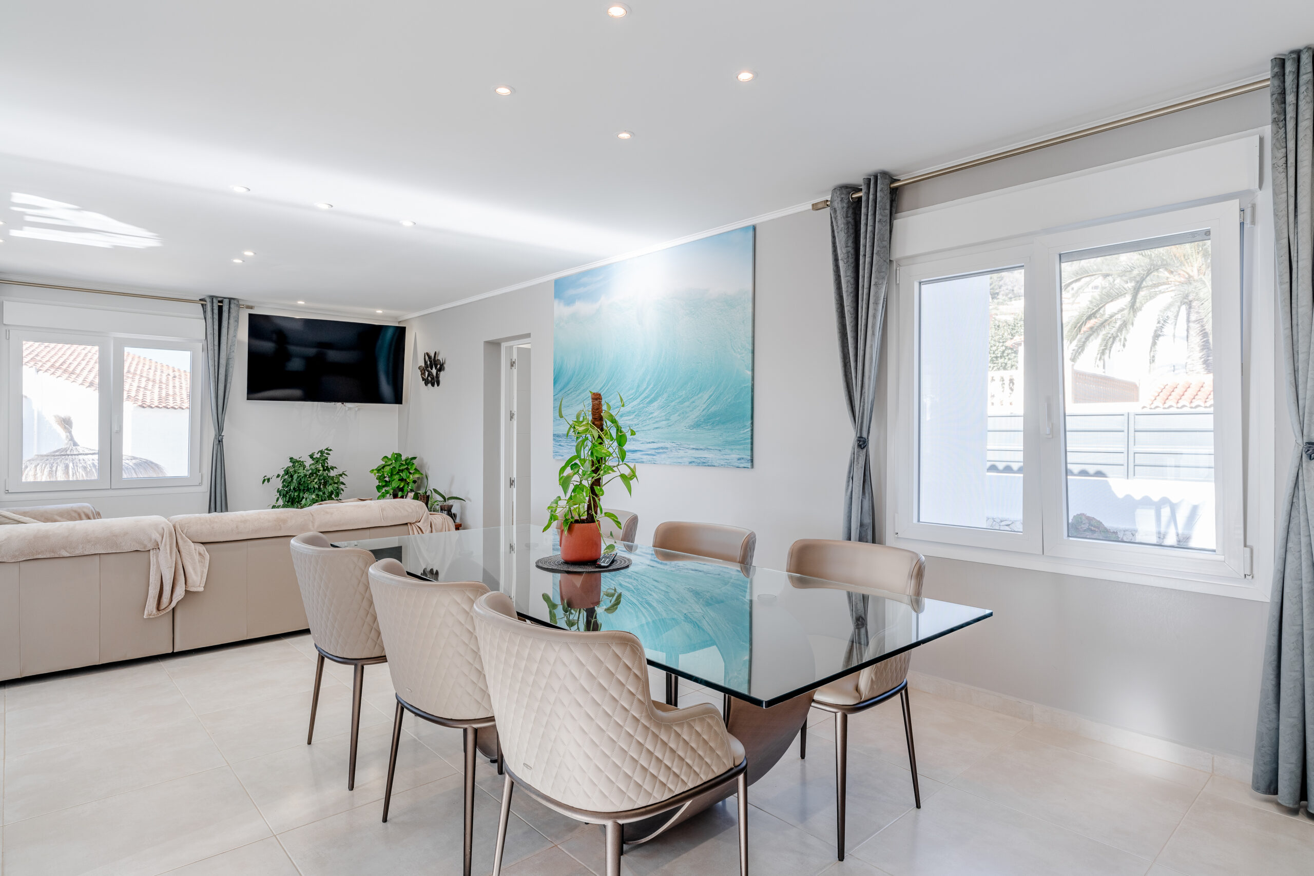 Open-plan living and dining room with large windows in a Calpe villa