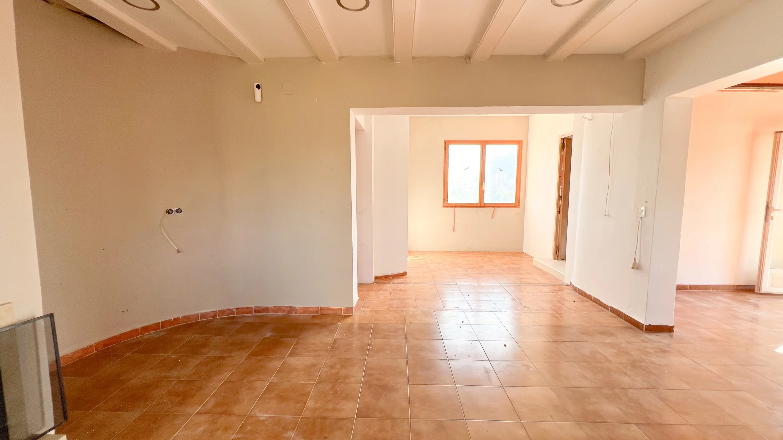 Open-plan living area with exposed beams in a renovation property in Calpe