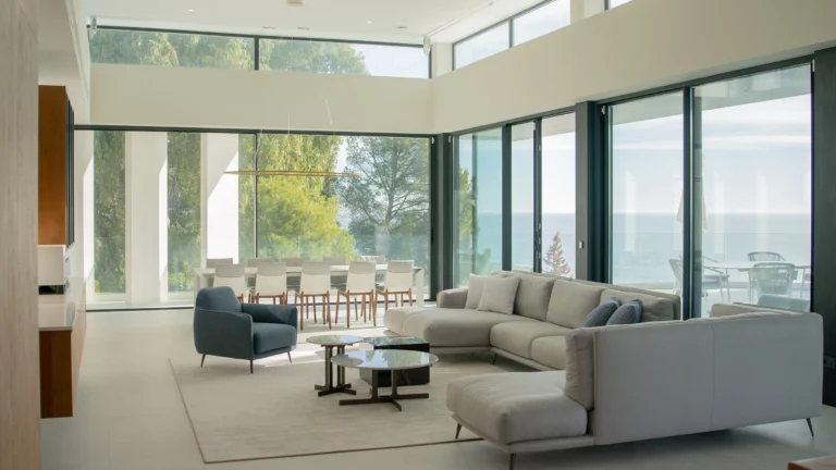 Open-plan lounge with panoramic glass windows at luxury villa in Altea