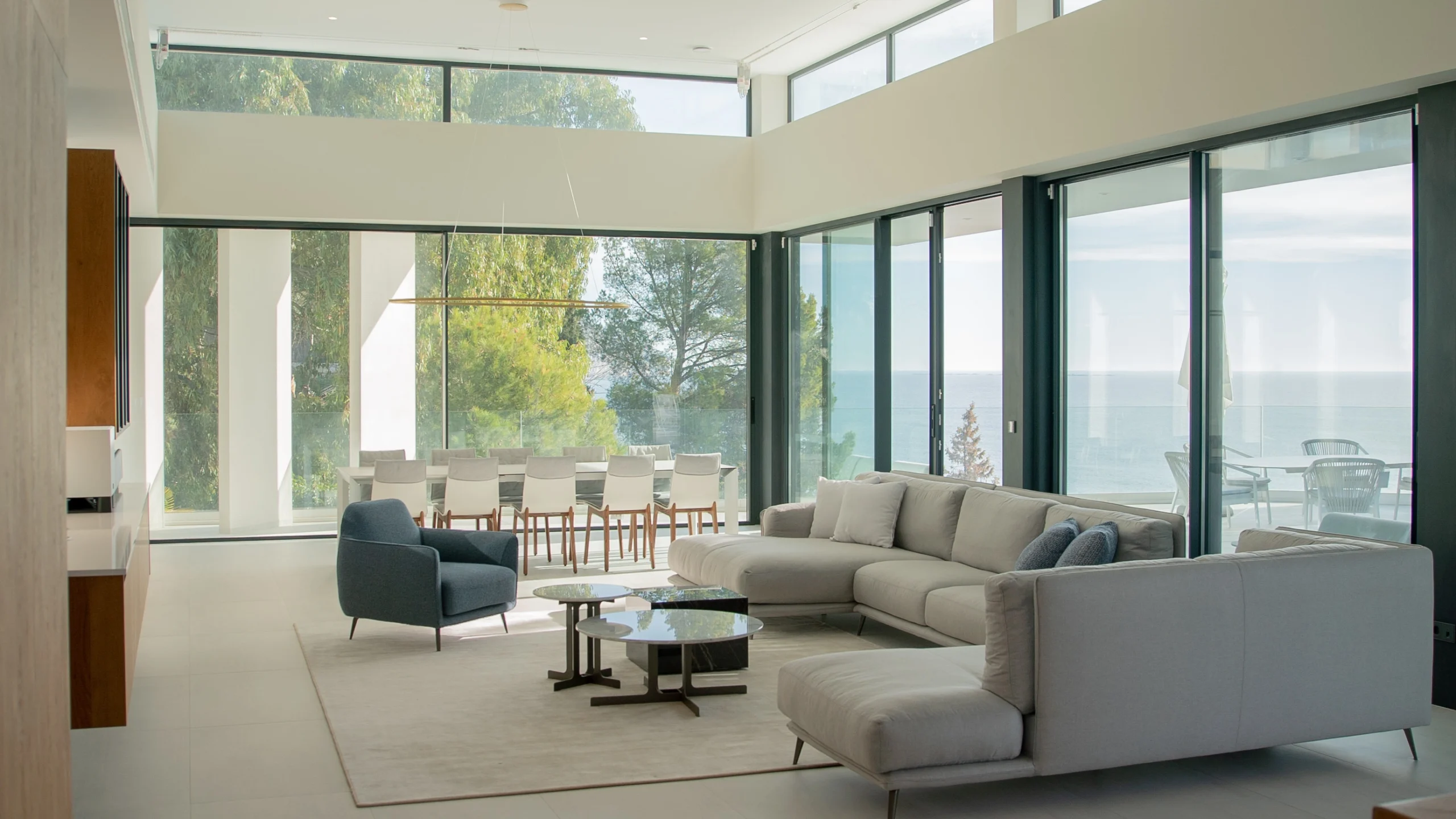 Open-plan lounge with panoramic glass windows at luxury villa in Altea