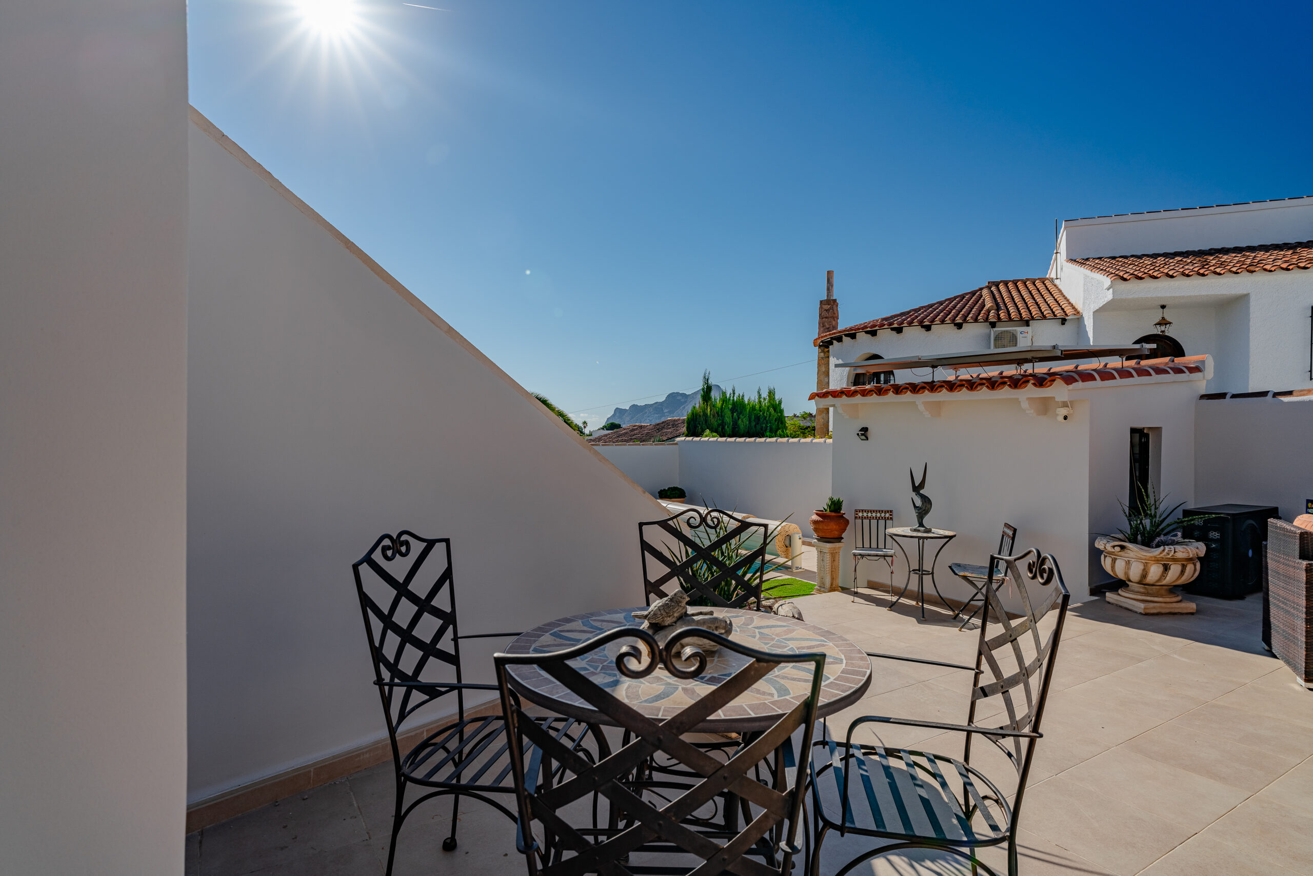 Outdoor dining terrace with iron furniture and sun exposure in a Calpe villa