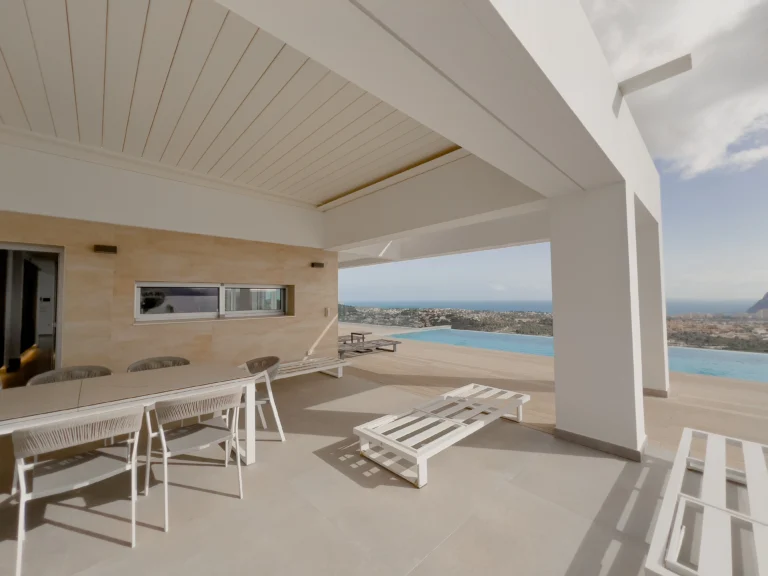 Panoramic terrace with sea views, sun loungers and covered dining area