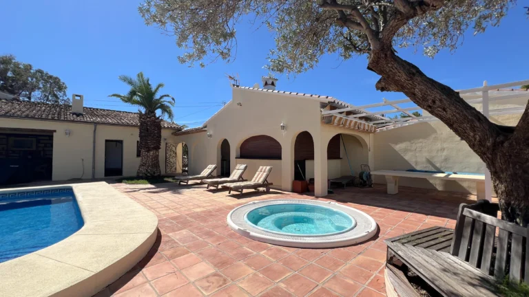 Pool terrace with jacuzzi and covered outdoor lounge in Benissa finca