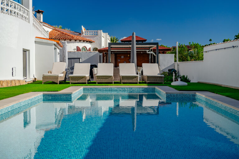 Private pool terrace with sun loungers beside a modern villa in Calpe