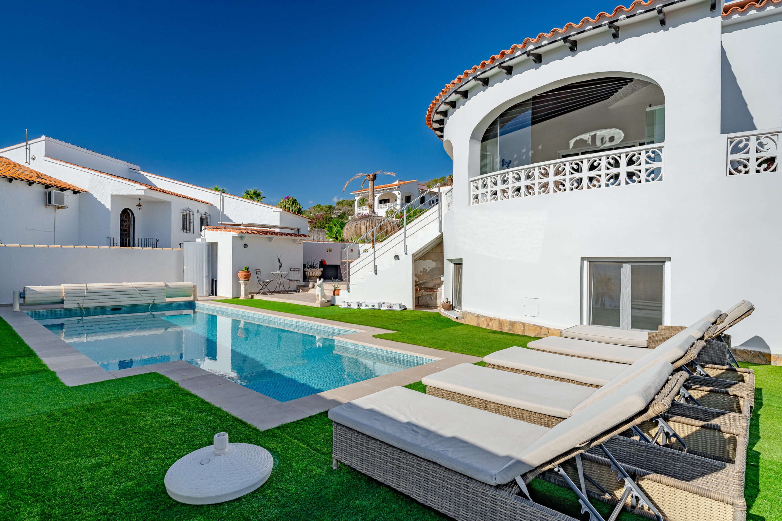 Private swimming pool with sun loungers at a modern Mediterranean villa in Calpe