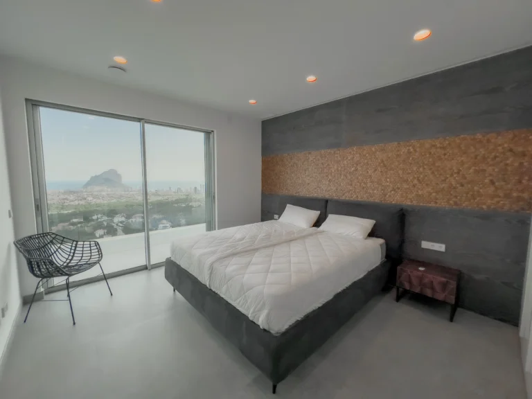 Sea-view double bedroom with modern accent wall in a luxury Calpe villa