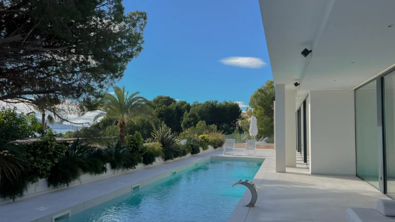 Sea-view infinity pool surrounded by pine trees at modern villa in Altea