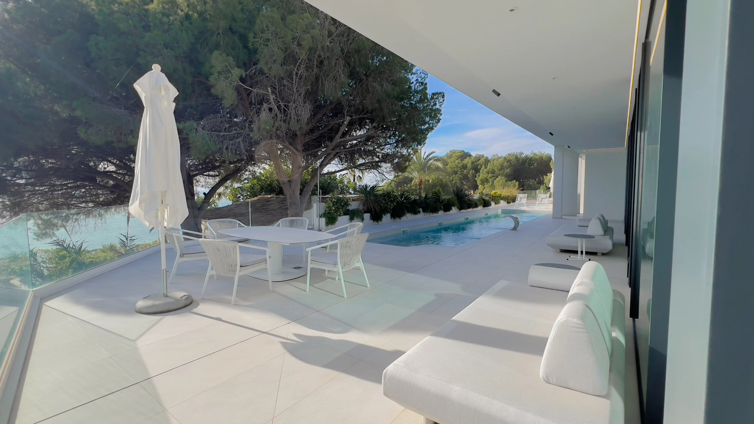 Seafront terrace with dining and sunbeds in modern villa Altea