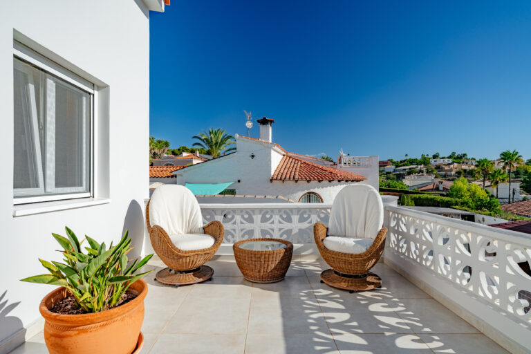 Small balcony seating area overlooking residential views in Calpe