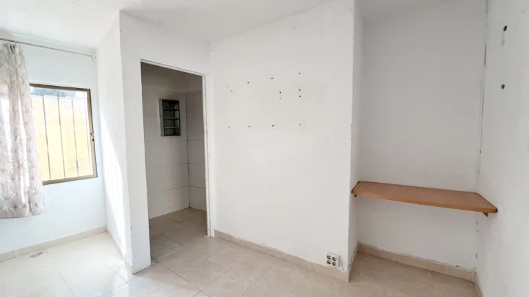 Small room with window and wall shelving in Calpe property for renovation