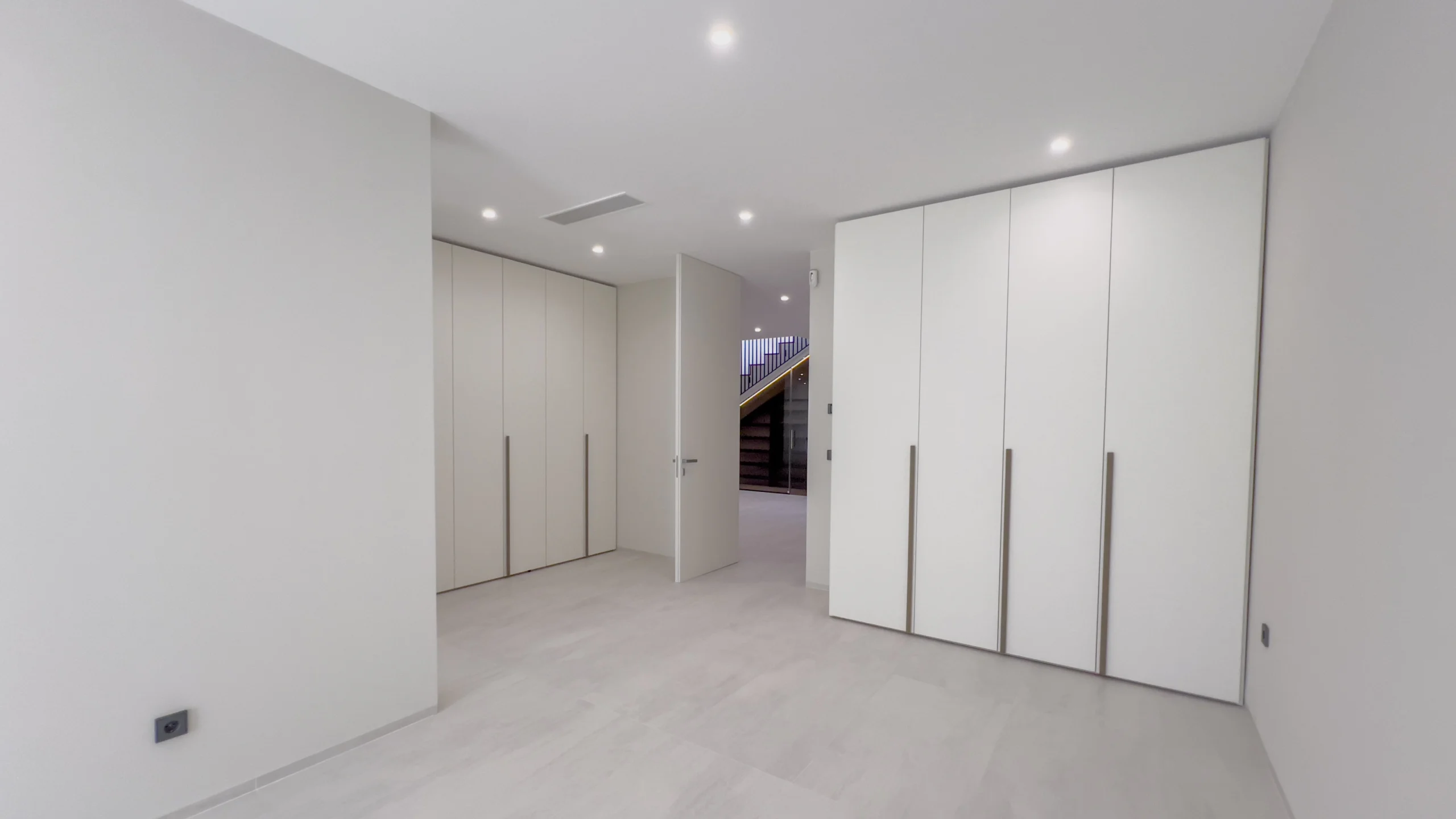 Spacious bedroom with built-in wardrobes in modern seafront villa Altea