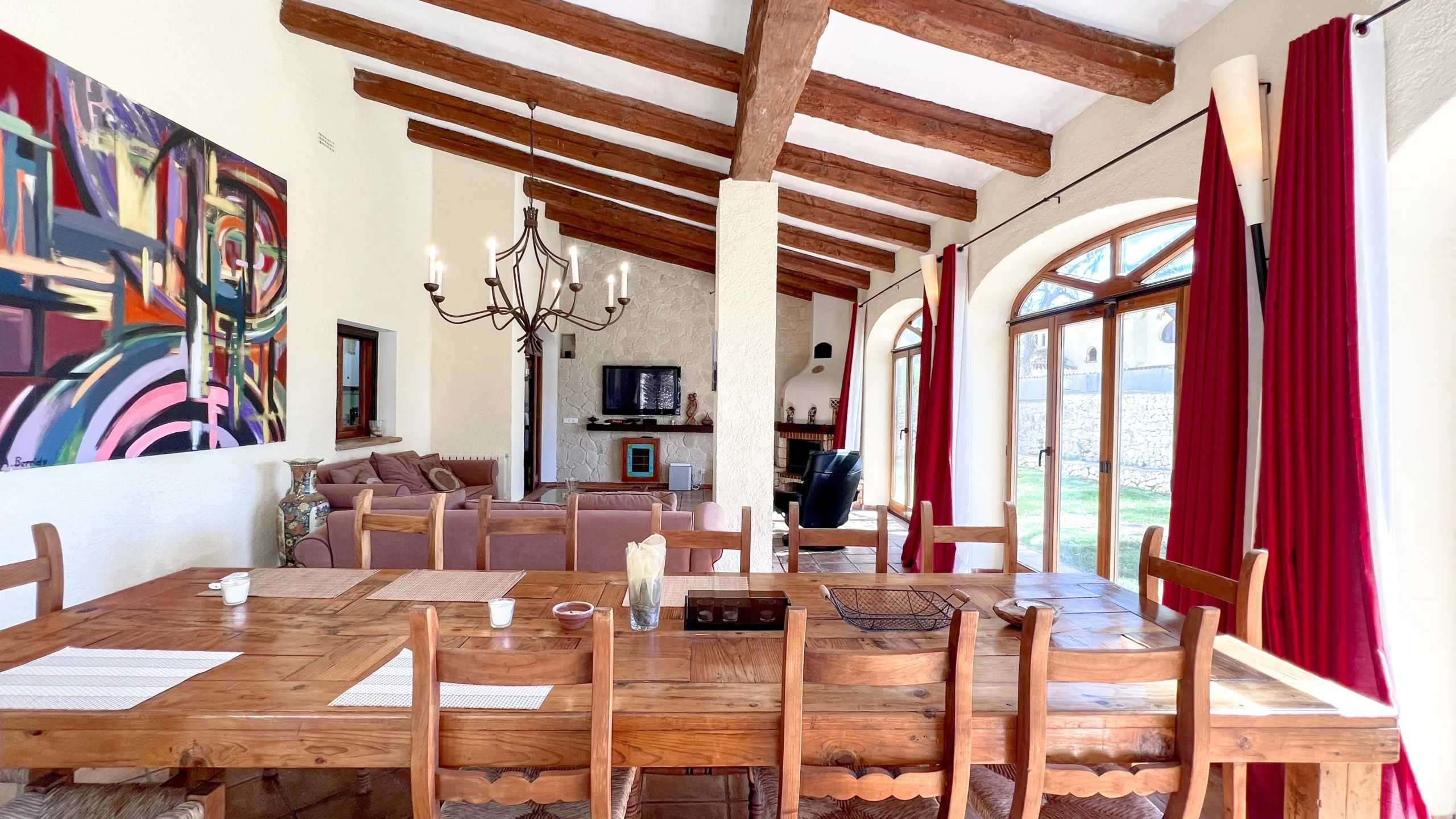 Spacious dining area with wooden table and vaulted beamed ceiling in Benissa countryside home