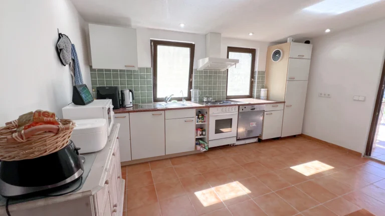 Spacious kitchen with green tile backsplash in Benissa rural home