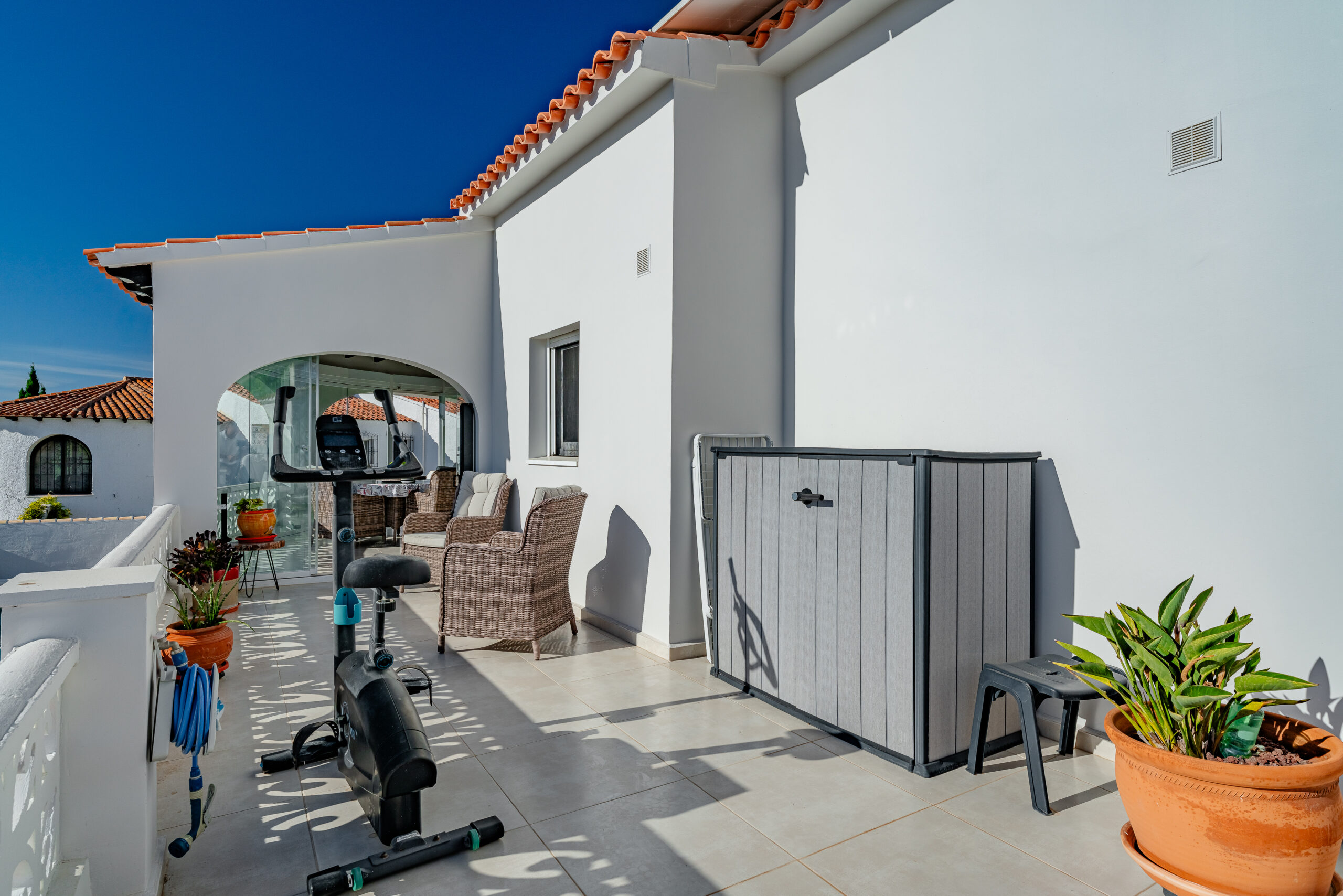 Terrace with outdoor seating and exercise equipment in a Calpe villa