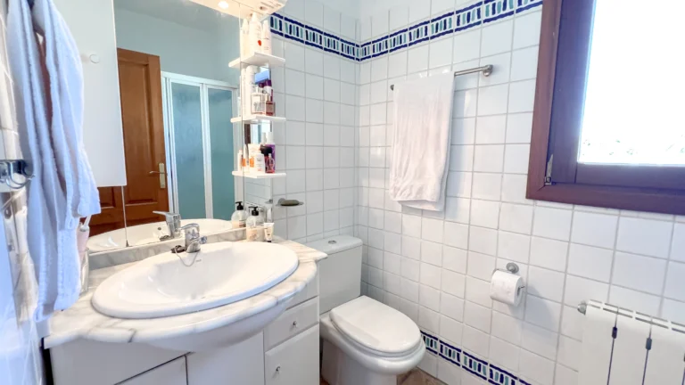 Traditional bathroom with tiled walls and vanity in rustic Benissa finca